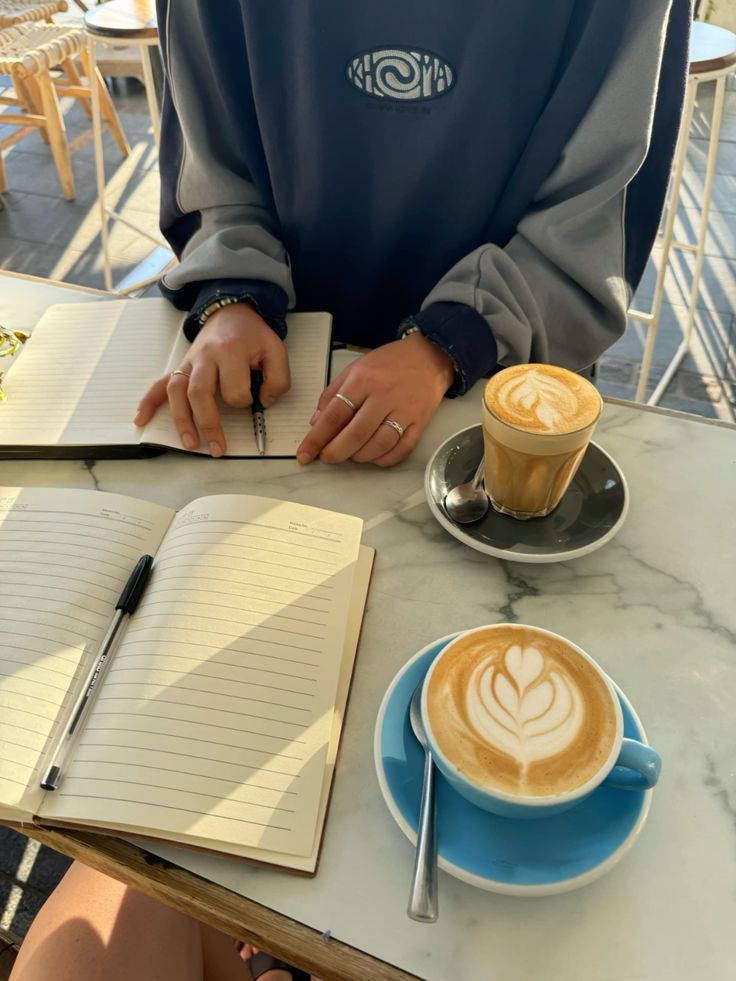 Krissie working with a client over coffee and a notebook